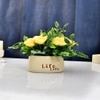 Yellow Artificial Flowers With A Modern Planter