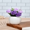 Artificial Lilac Hues Flowers With A White Textured Planter