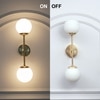 Balts Twin Wall Light In Brass Finish With Opal Glass Globe Shades