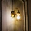 Hendrik Single Light Brass Wall Fitting with Amber Glass