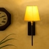 Devansh Metal Electric Wall Light in Black Colour with Yellow Shade Count of 1 Light