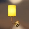 Devansh Metal Electric Wall Light in Gold Colour with Yellow Shade Count of 1 Light