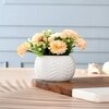 Artificial Flowers With A White Textured Planter