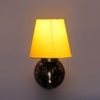 Devansh Metal Electric Wall Light in Antique Gold Colour with Yellow Shade Count of 1 Light
