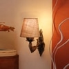 Devansh Metal Electric Wall Light in Antique Gold Colour with Beige Shade Count of 1 Light