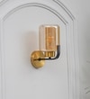 Isabella Single Light Wall Fitting In Black And  Brass  Finish Metal With Amber Glass