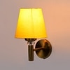 Devansh Metal Electric Wall Light in Gold Colour with Yellow Shade Count of 1 Light