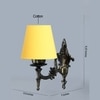 Devansh Metal Electric Wall Light in Antique Gold Colour with Yellow Shade Count of 1 Light