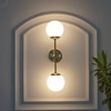 Balts Twin Wall Light In Brass Finish With Opal Glass Globe Shades