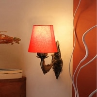 Devansh Metal Electric Wall Light in Antique Gold Colour with Orange Shade Count of 1 Light
