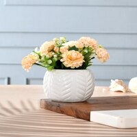 Artificial Flowers With A White Textured Planter