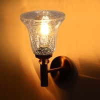 Devansh Metal Electric Wall Light in Gold Colour with Transparent Shade Count of 1 Light