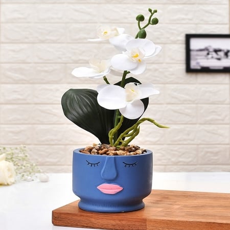 Artistic Blue Face Planter With White Artificial Orchids