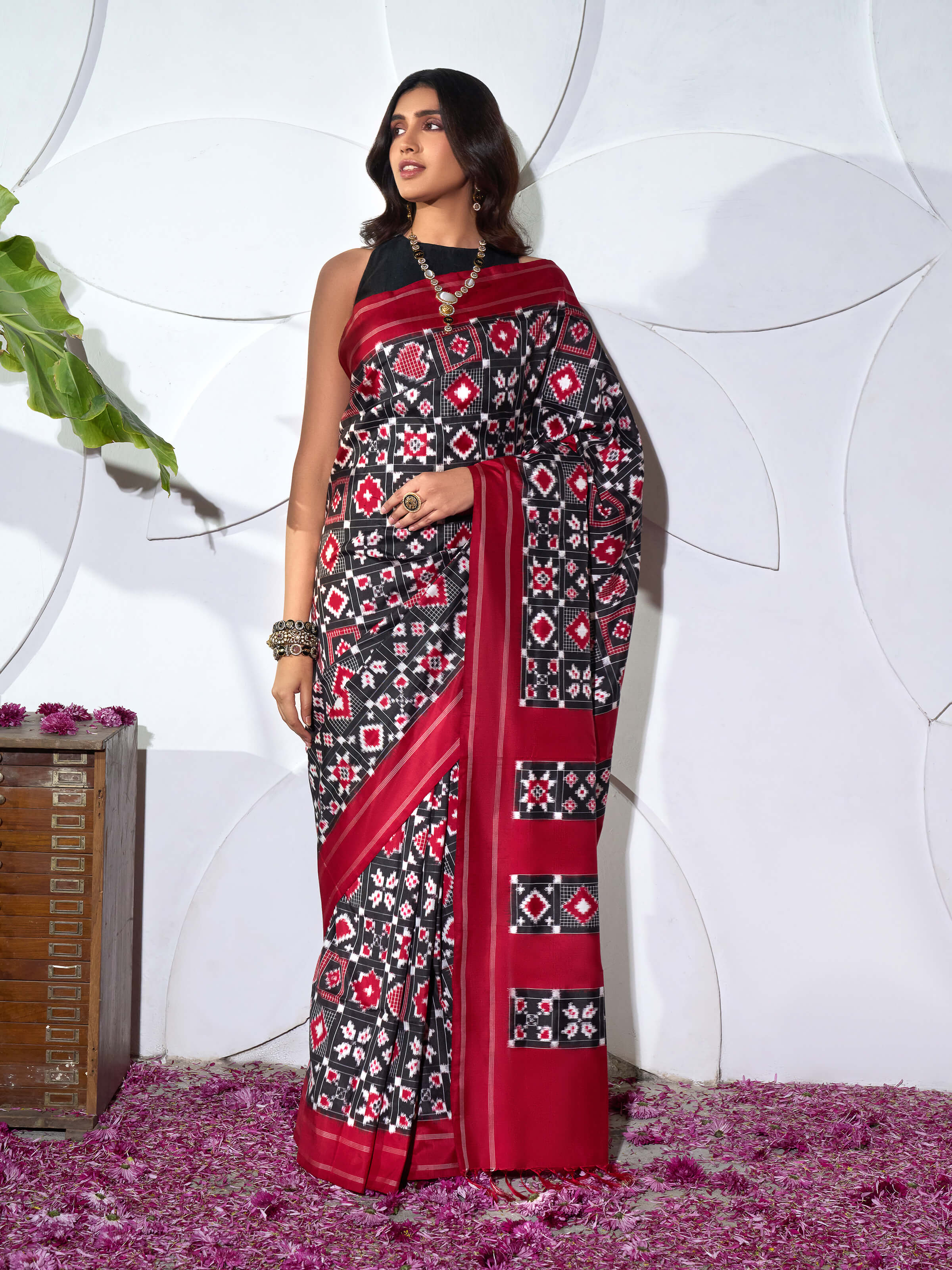 Side view of red silk Telia Rumal double ikat saree with graceful drape and patterned border