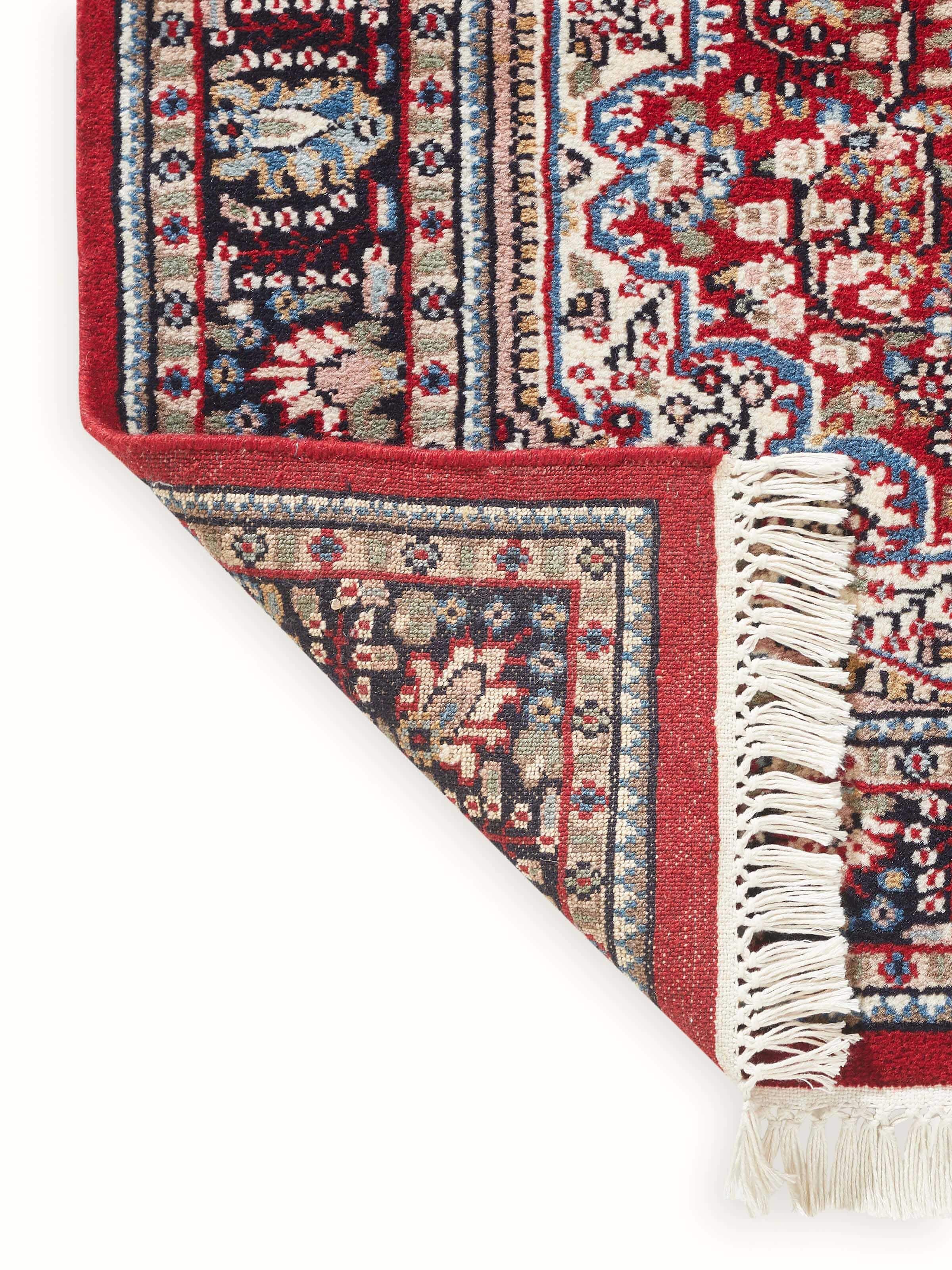 Back view of Persian red Oriental Gwalior wool hand-knotted carpet revealing clean knots and tightly woven finish.