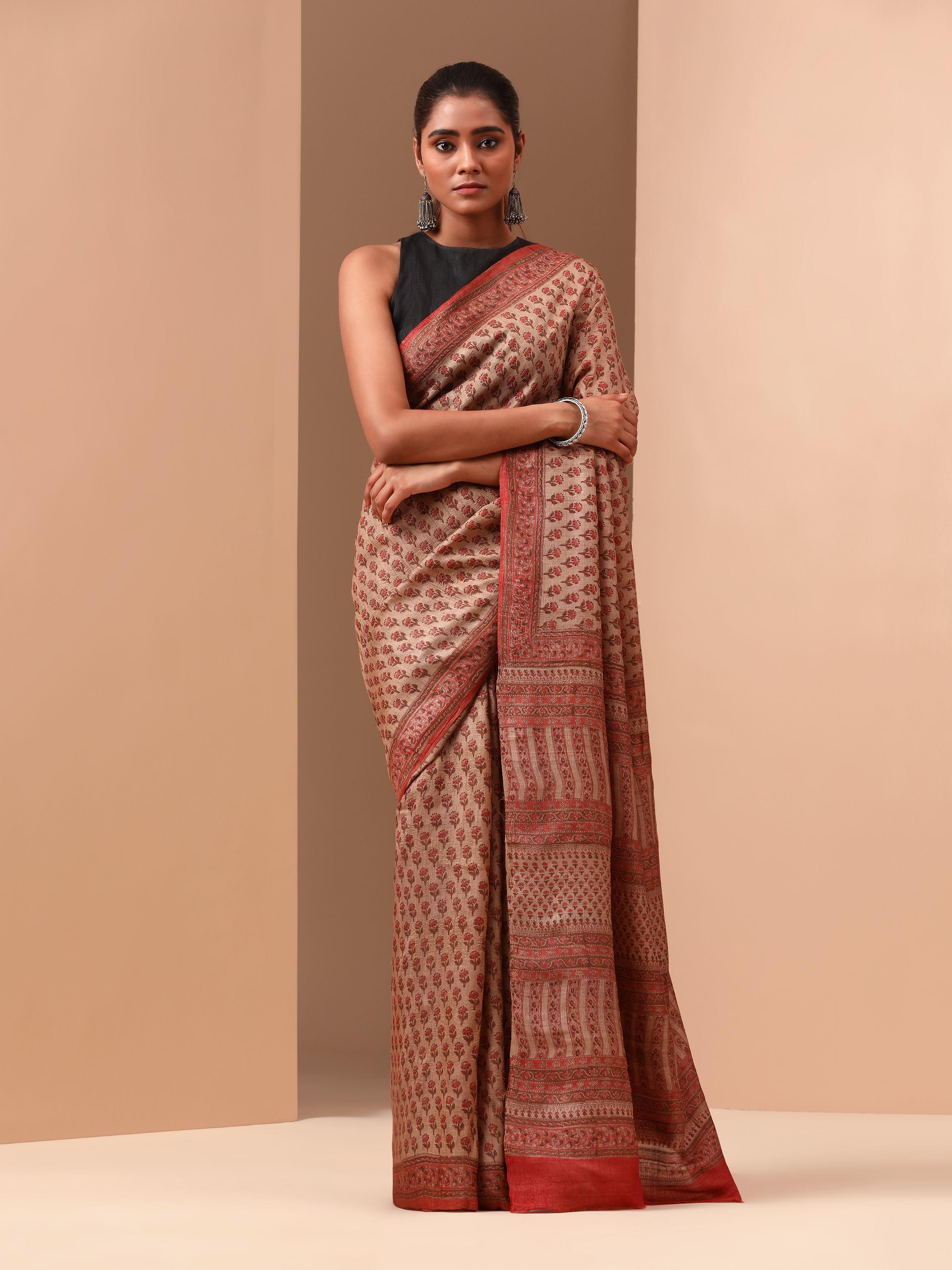 Lifestyle shot of Red Tussar Muga Silk Bagru Block Printed Saree draped on model