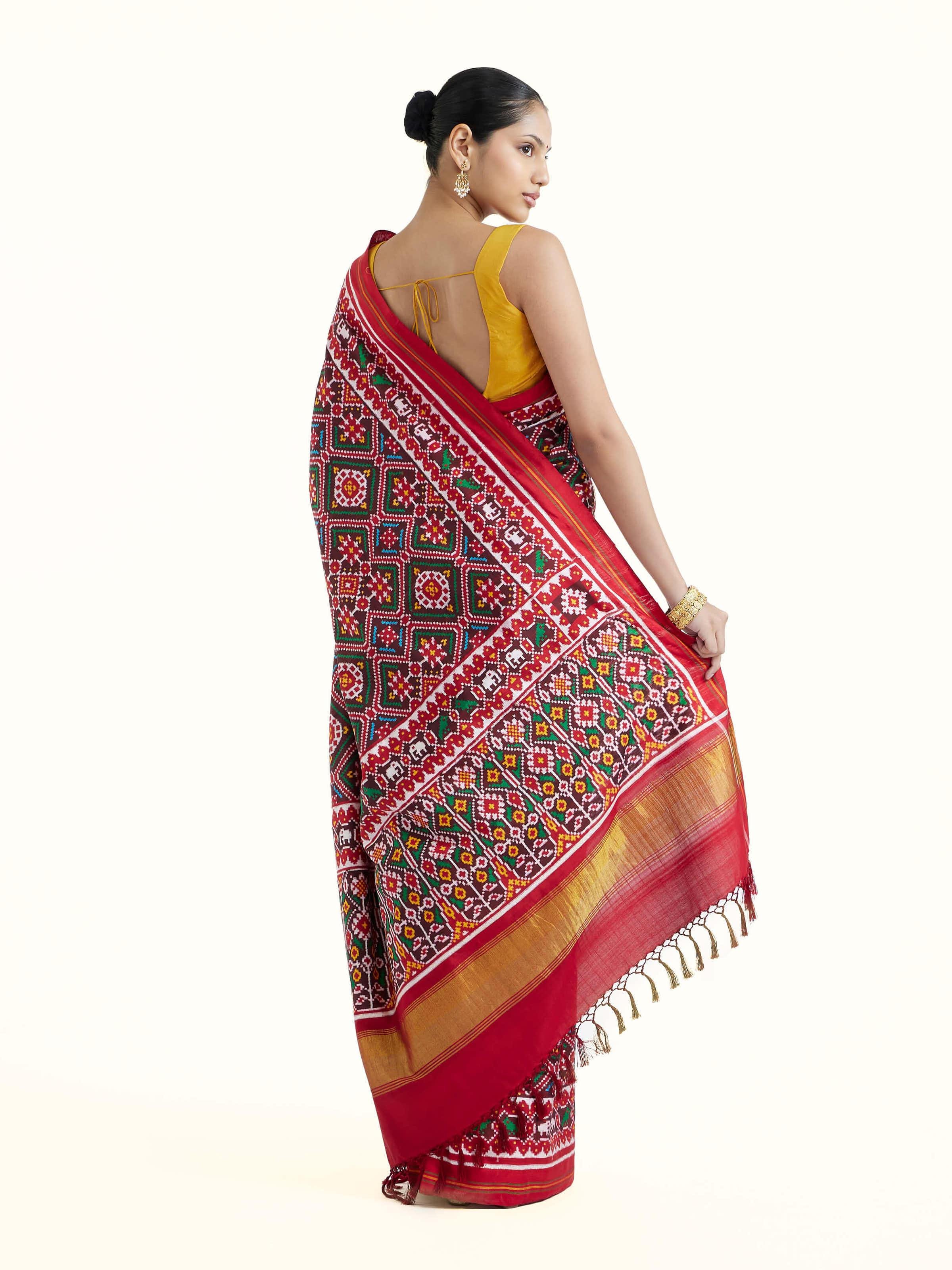 Back view of brown silk Patola saree displaying elaborate pallu design