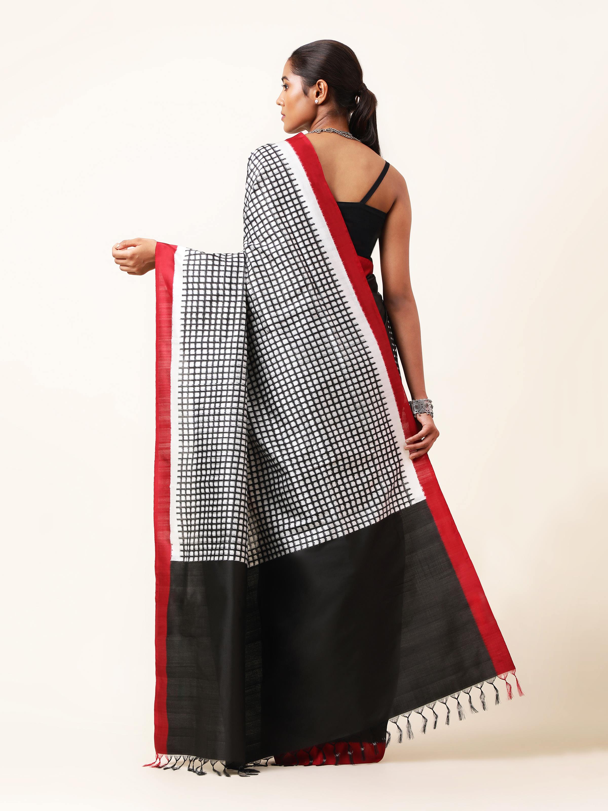 Back view of black silk double ikat saree showing full drape and pattern details