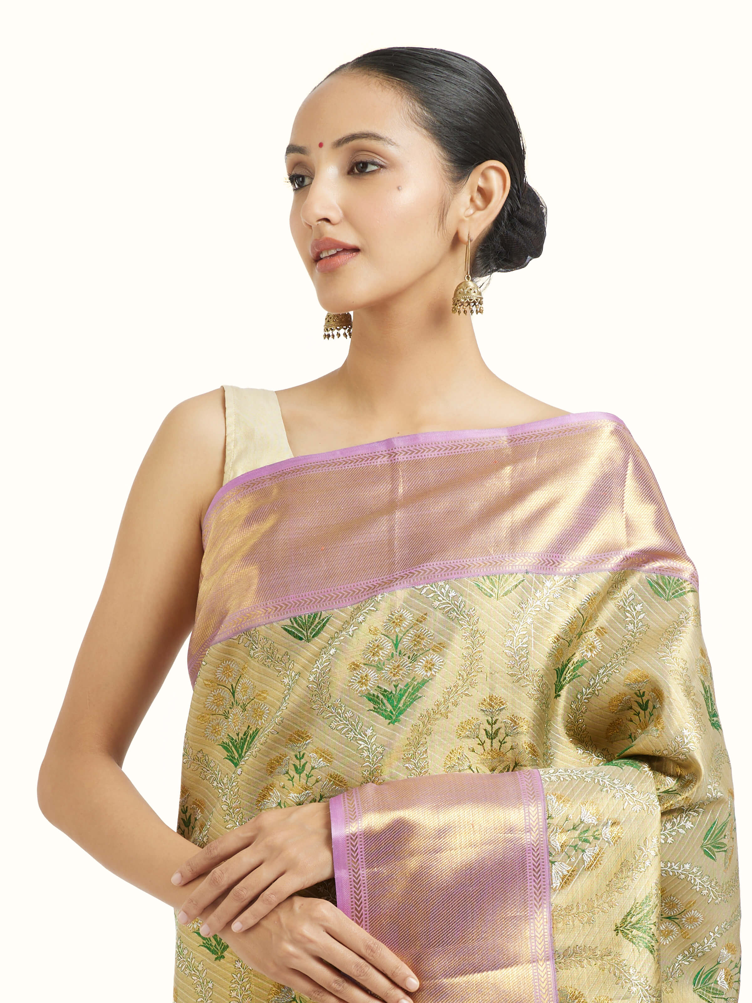 Angled view of gold silk Kancheepuram saree highlighting traditional weave