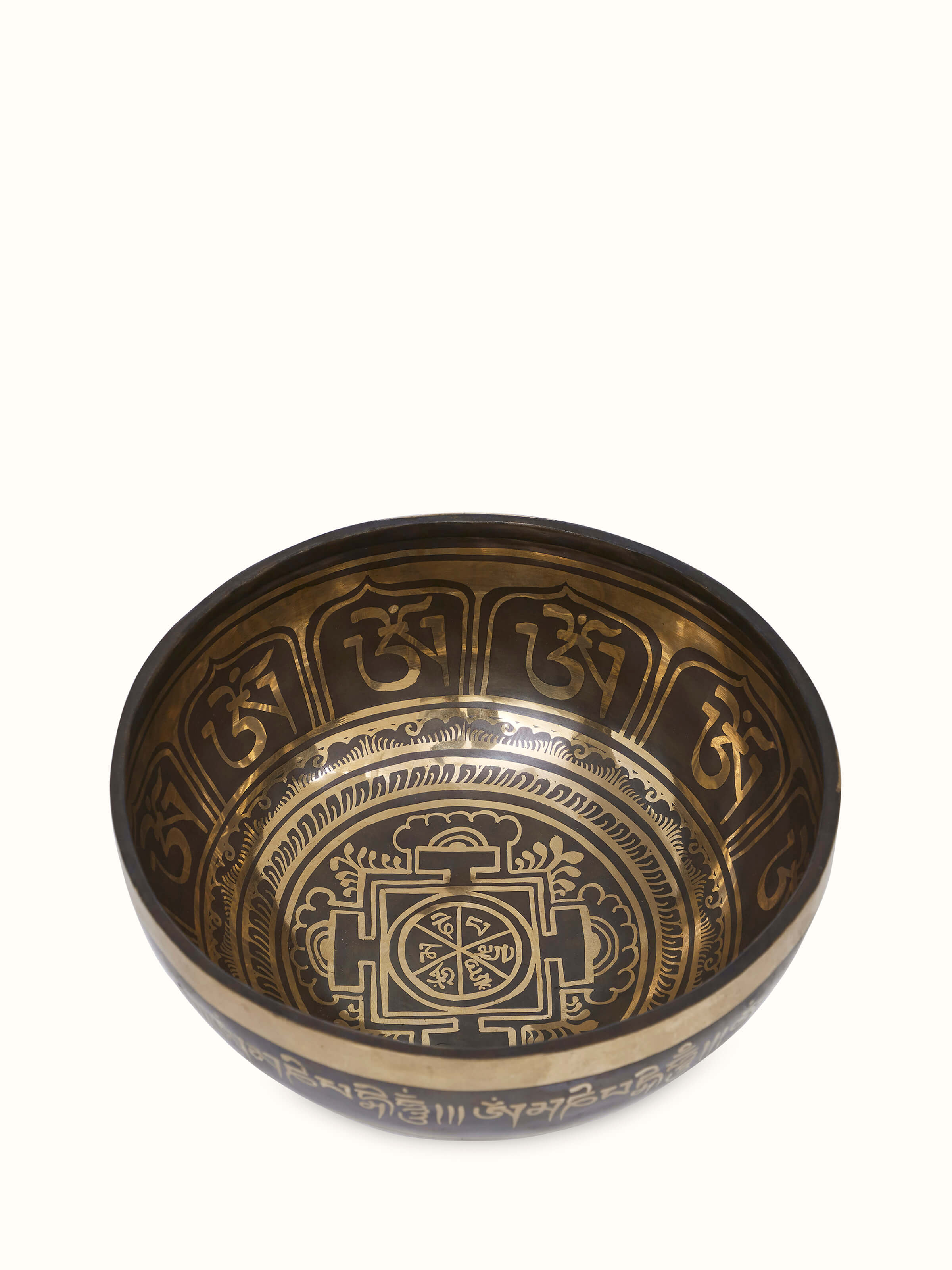 Angled view of Om Mandal Singing Bowl (10 Inches) displaying the rich bronze tone and carved symbols