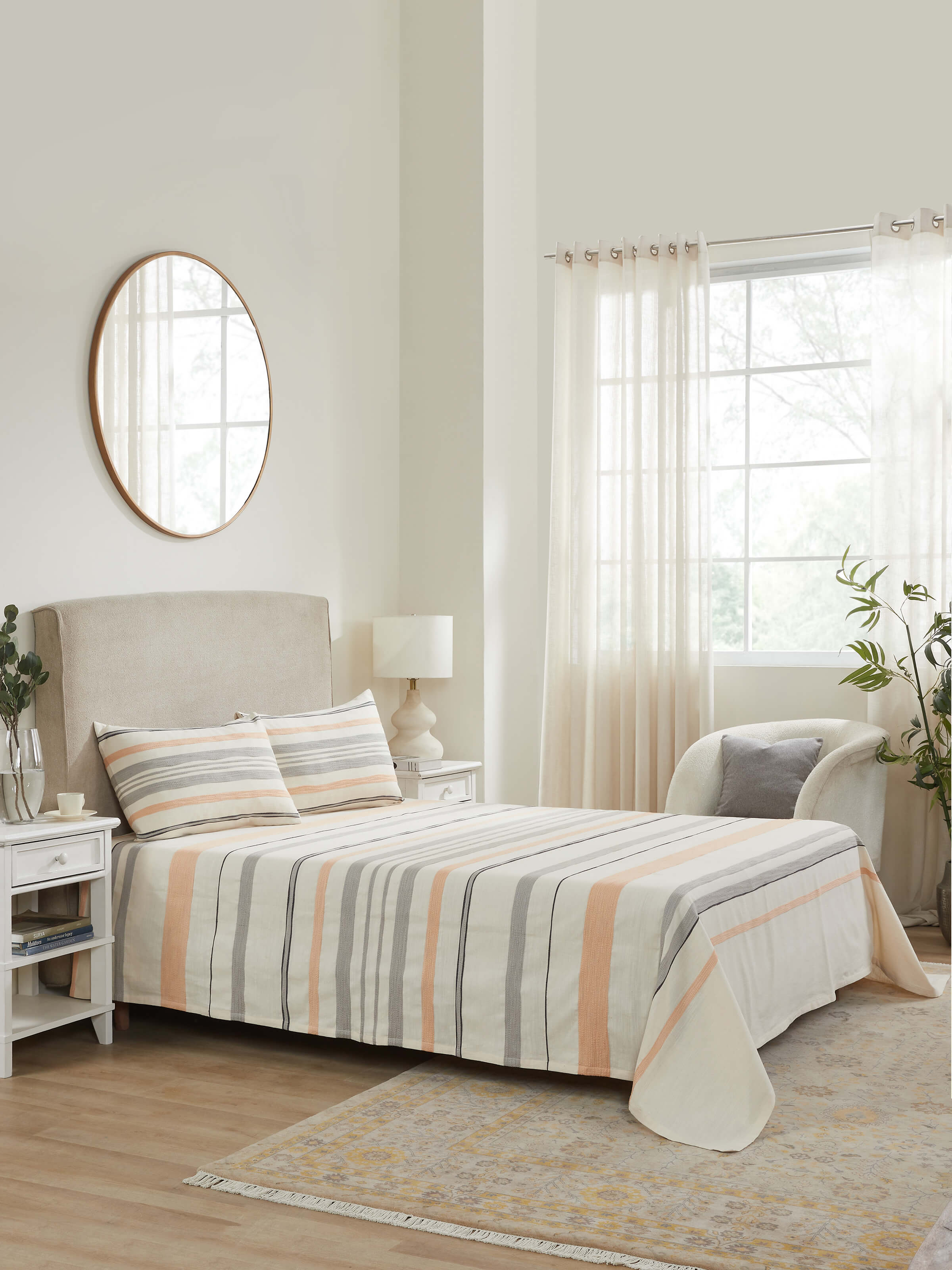 Lifestyle view of Neerja grey stripe cotton bedspread set styled on a wooden queen bed