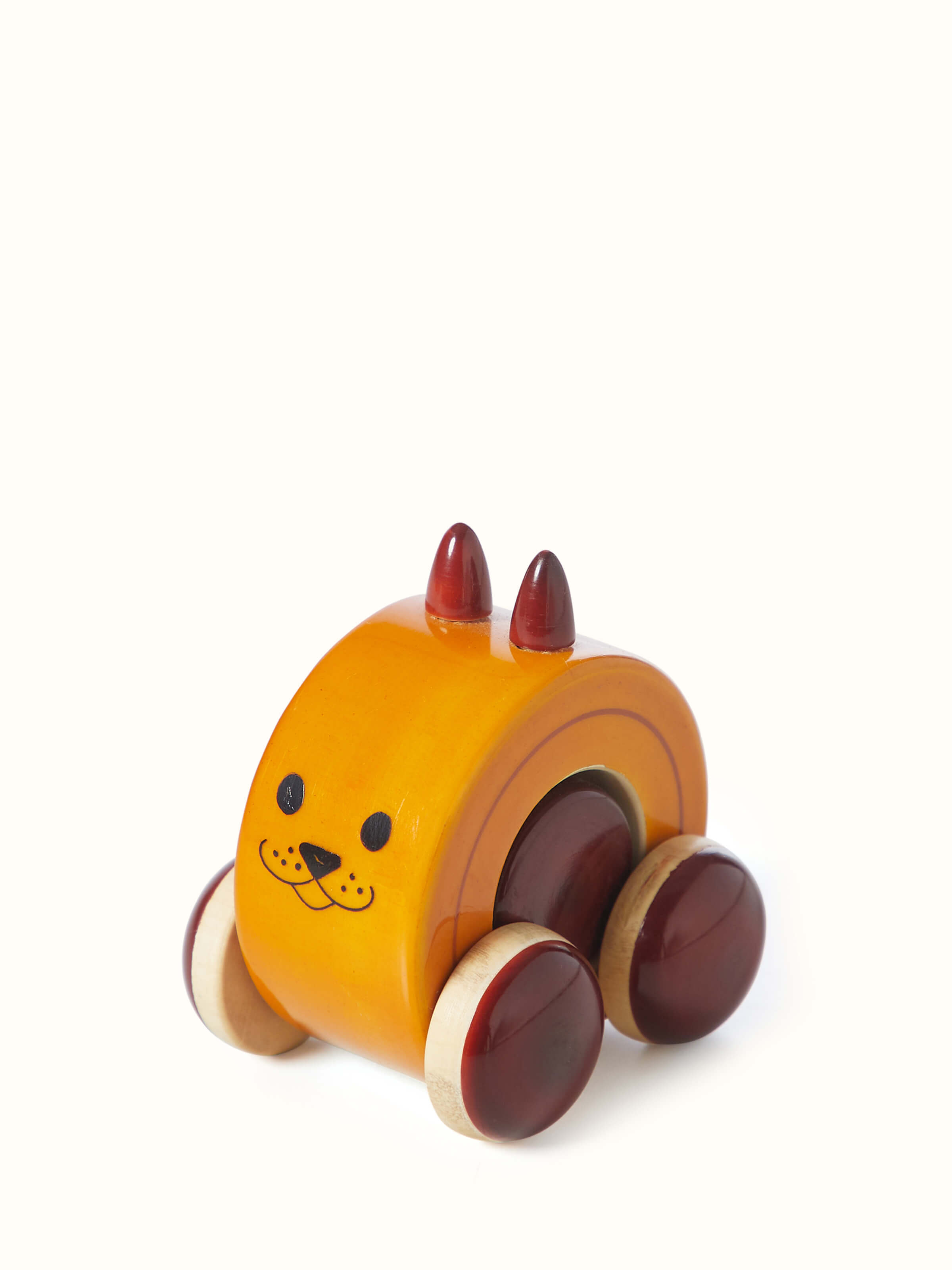 Close-up of Channapatna Ivory Wood Moee Toy Yellow showing detailed craftsmanship