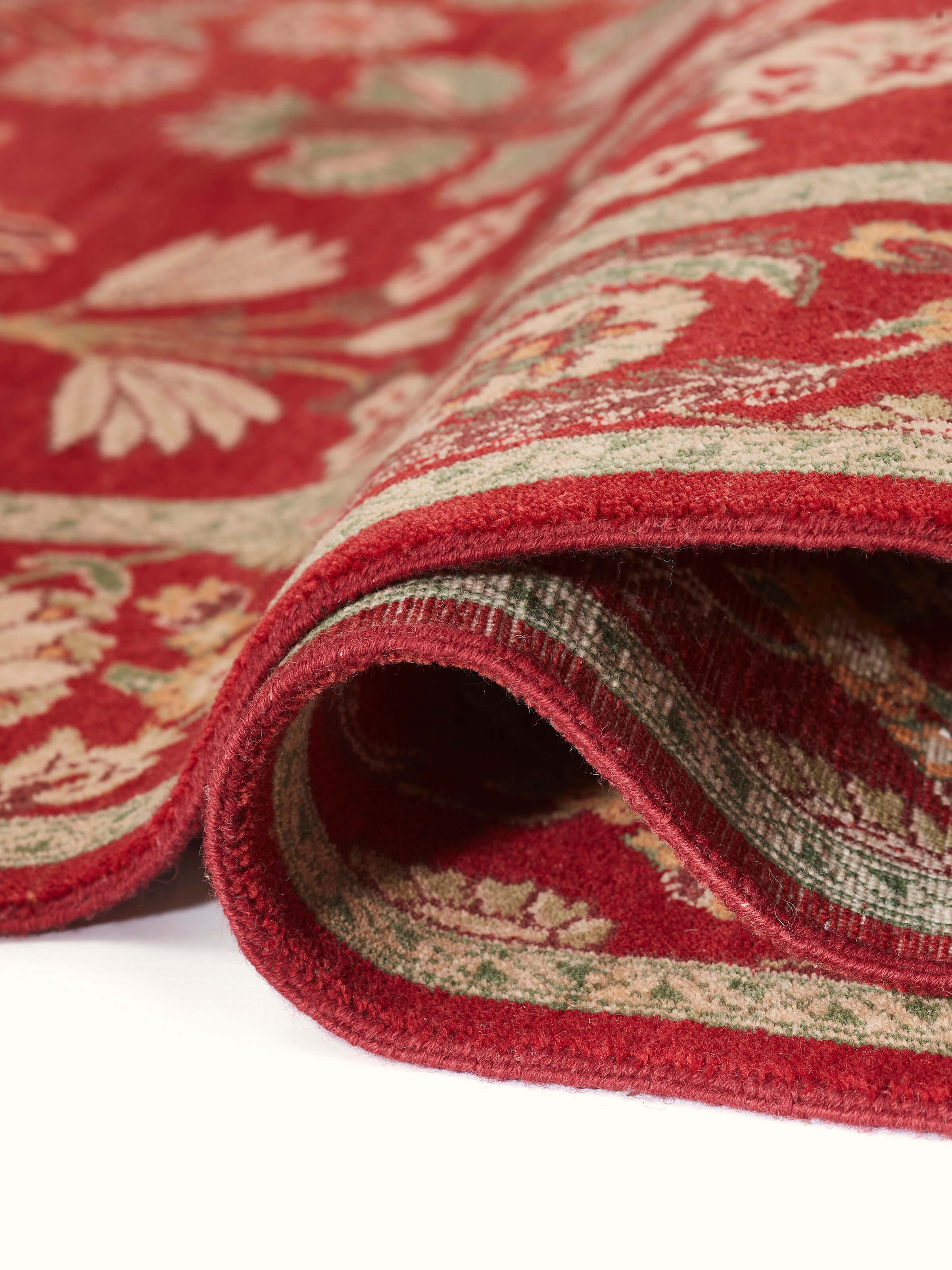 Detailed texture shot of Red Agra Wool Carpet emphasizing traditional hand-knotting technique and vibrant colors