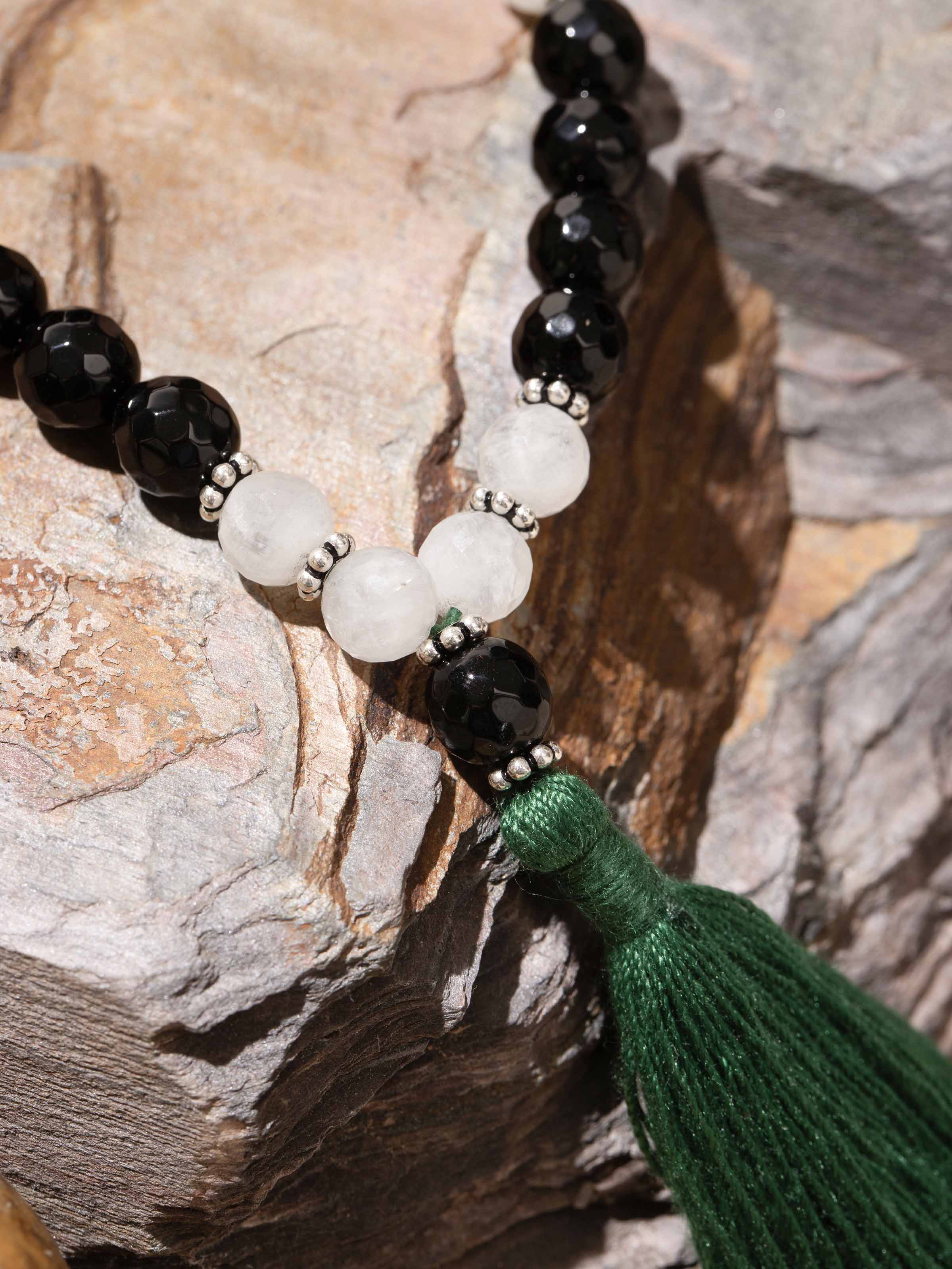 Close-up display of Rubicozite & Moonstone Mala showing polished stones and fine craftsmanship