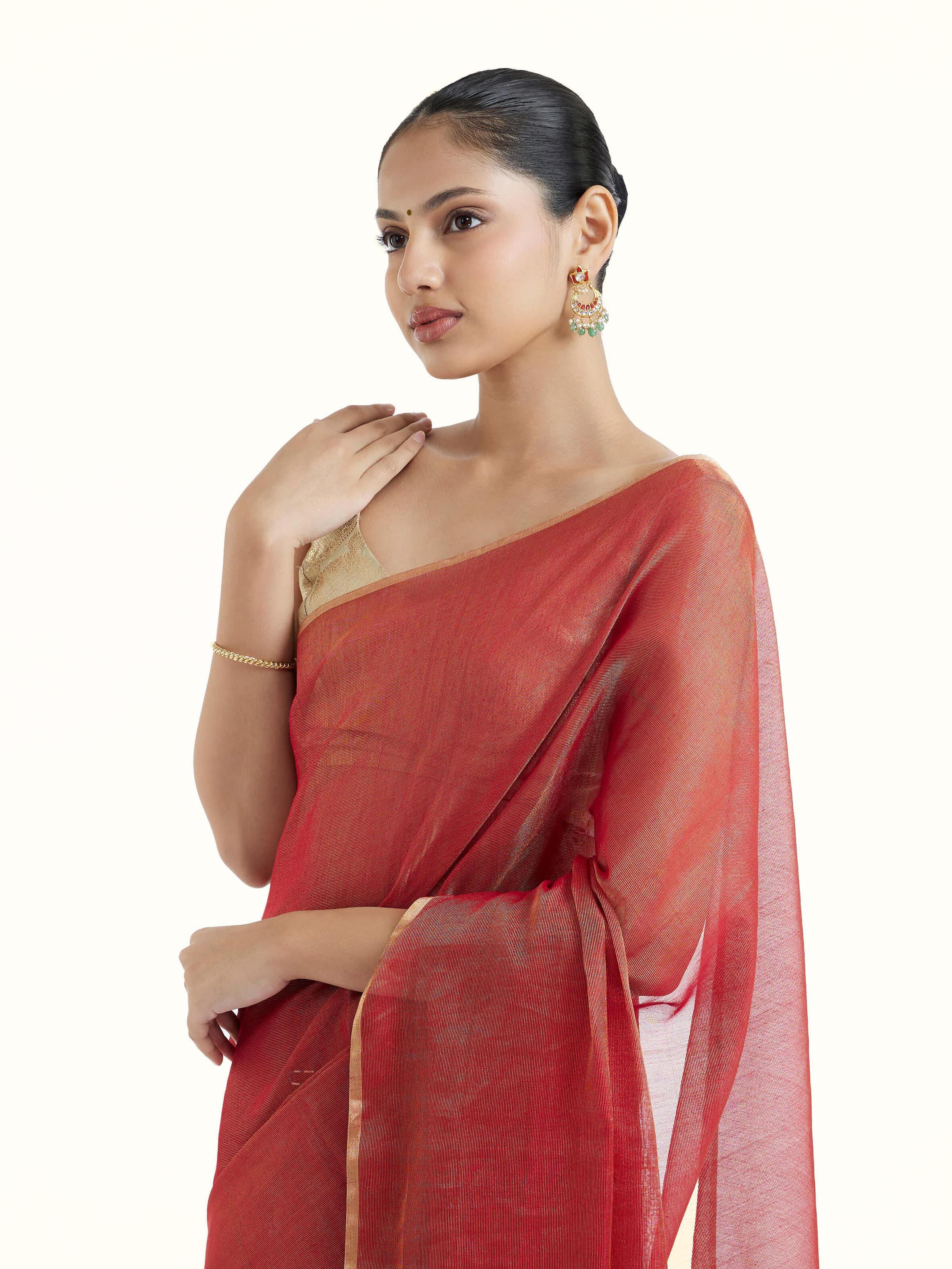 Angled view of red cotton silk Maheshwari saree highlighting woven patterns