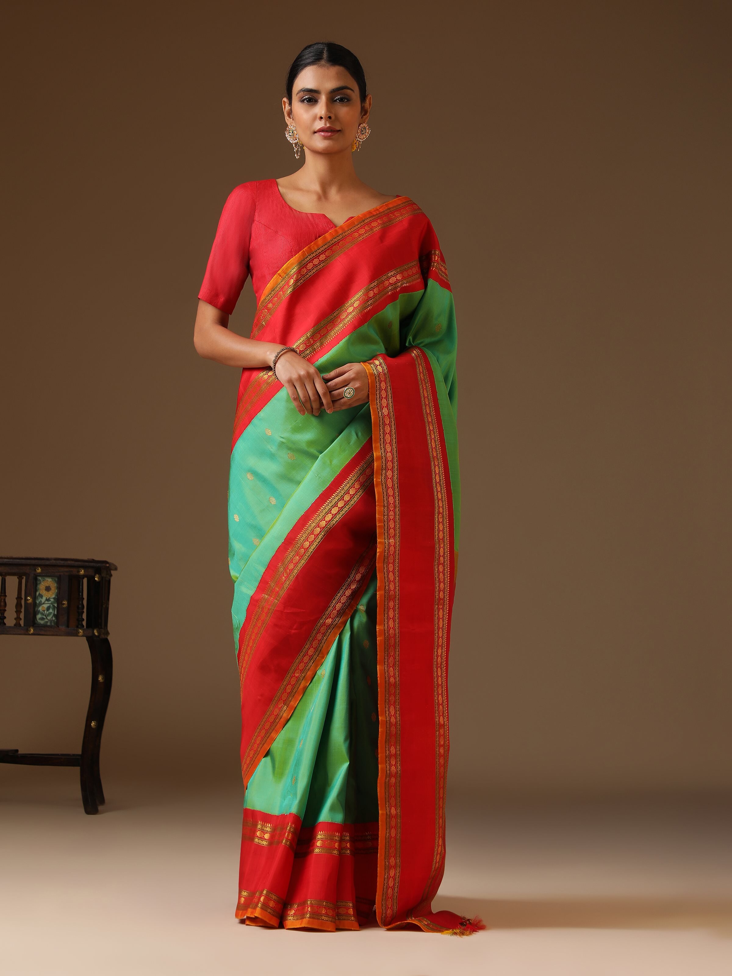 Side lifestyle image capturing the intricate zari border and weaving details.