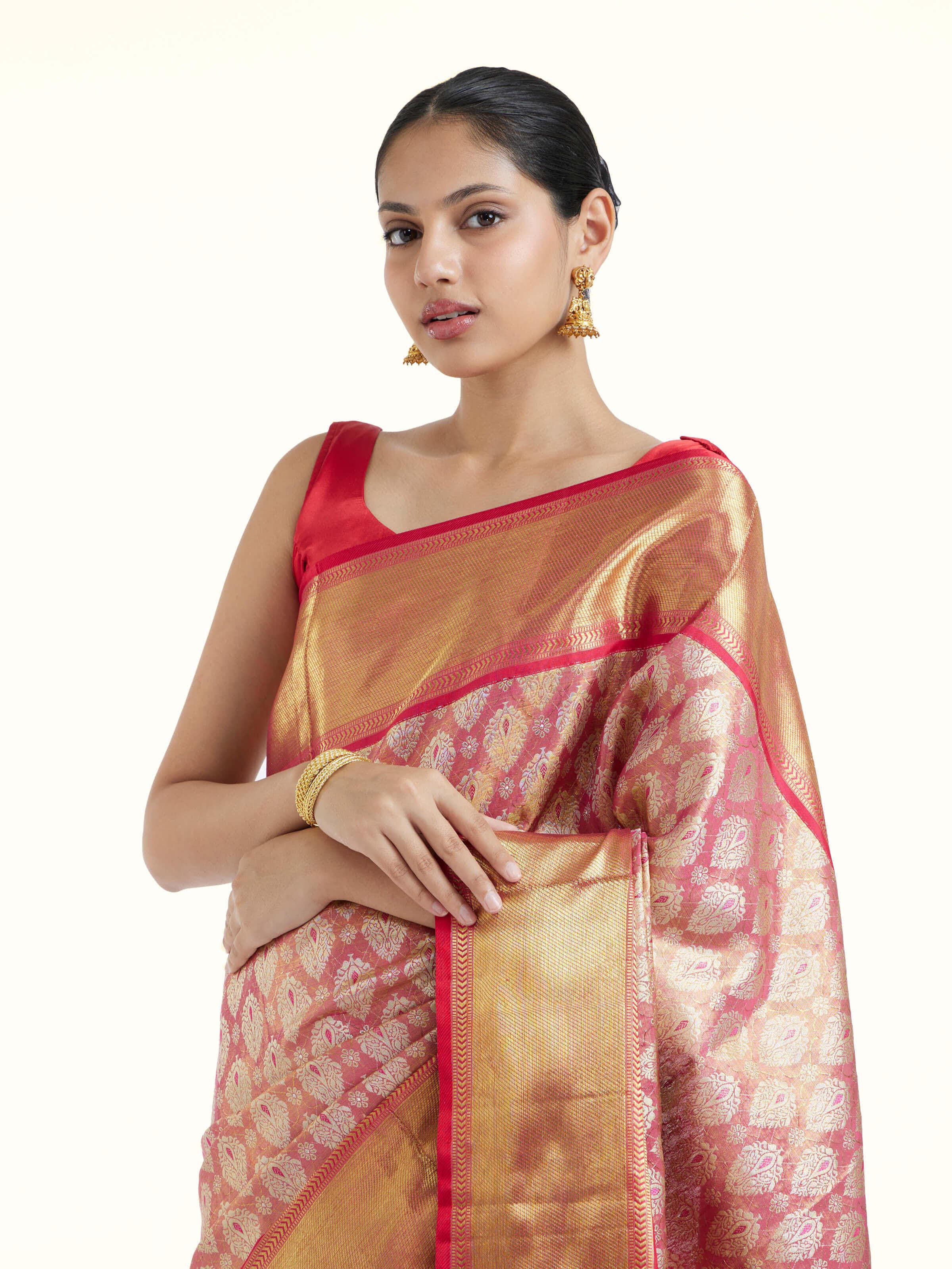 Angled view of pink silk Kancheepuram saree highlighting traditional weave and sheen