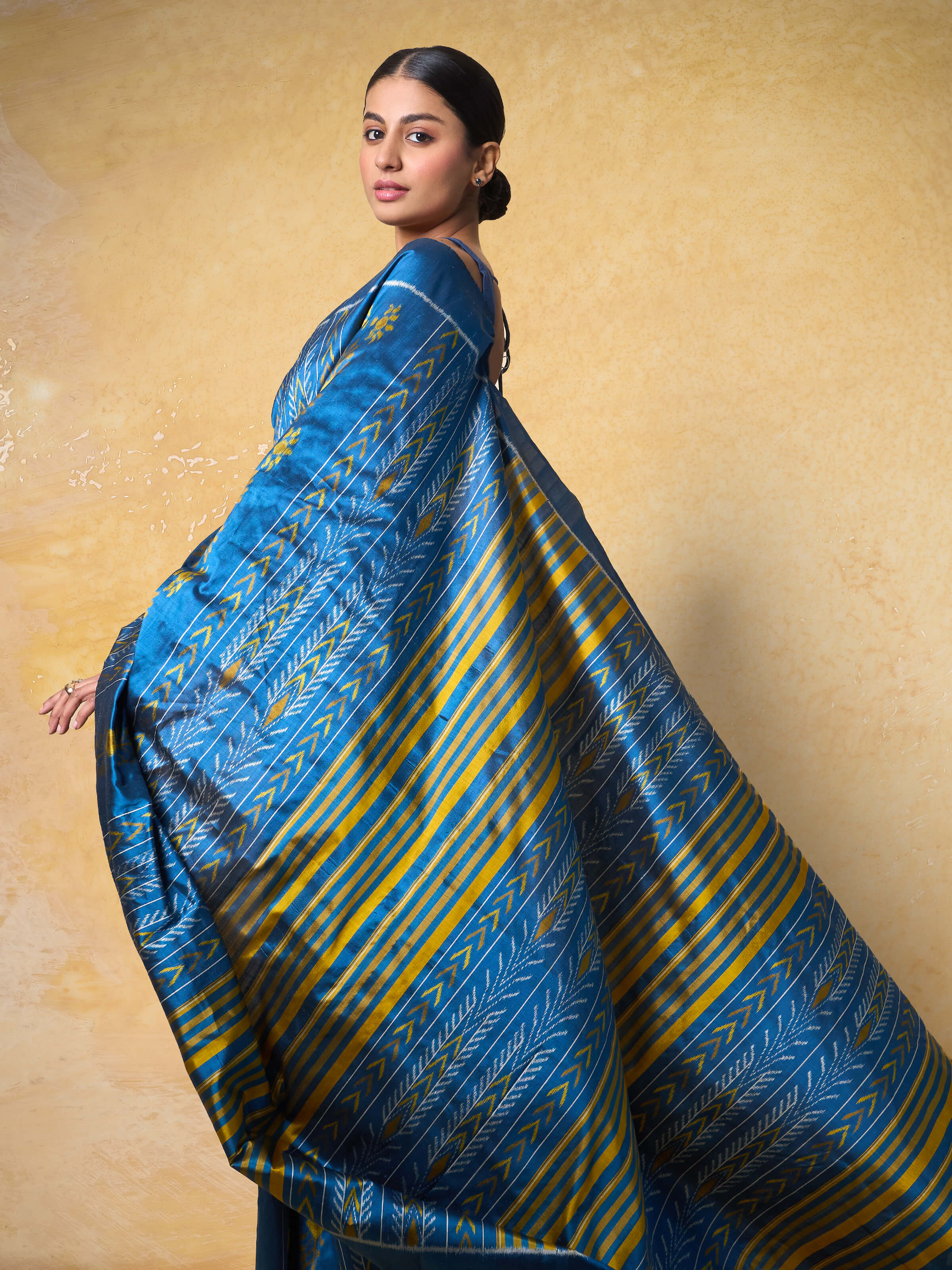 Angled view of Blue Mulberry Silk Odisha Ikat Saree revealing the depth of its color and pattern.