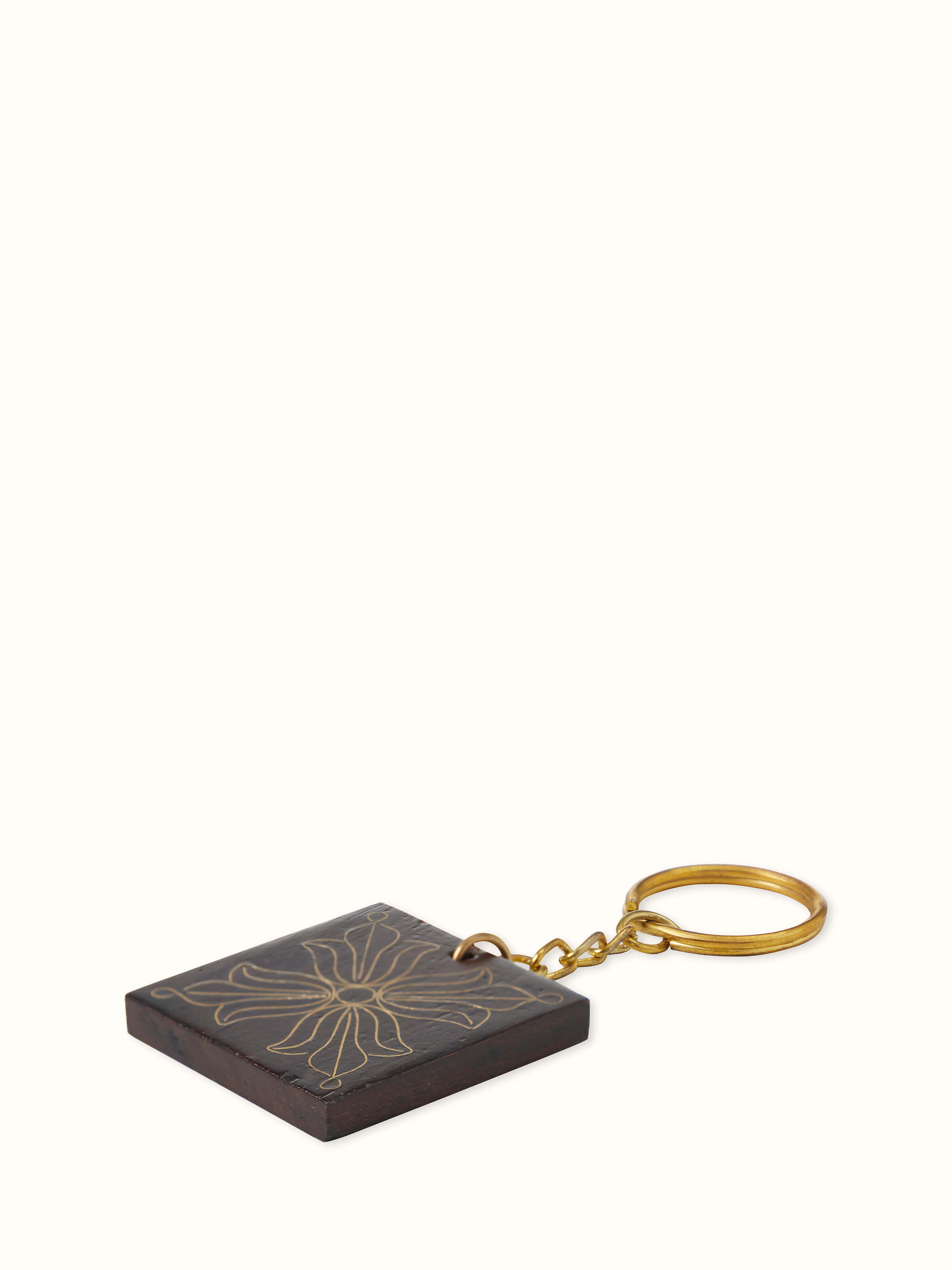 Detailed view of Tarkashi Sheesham wood & brass keychains highlighting their intricate woodwork and brass design