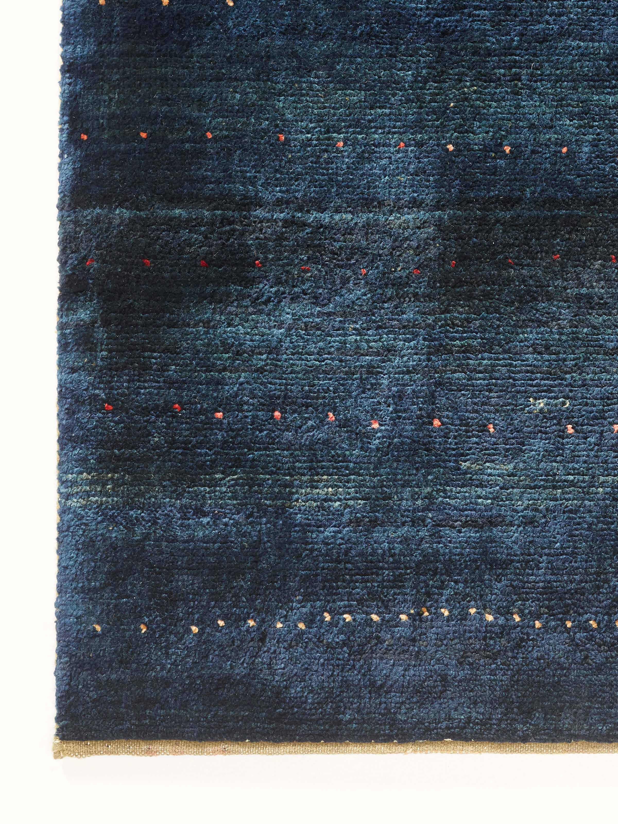 Close-up of the Traditional Gabbeh blue Jaipur wool hand-knotted carpet, highlighting the wool's detail.