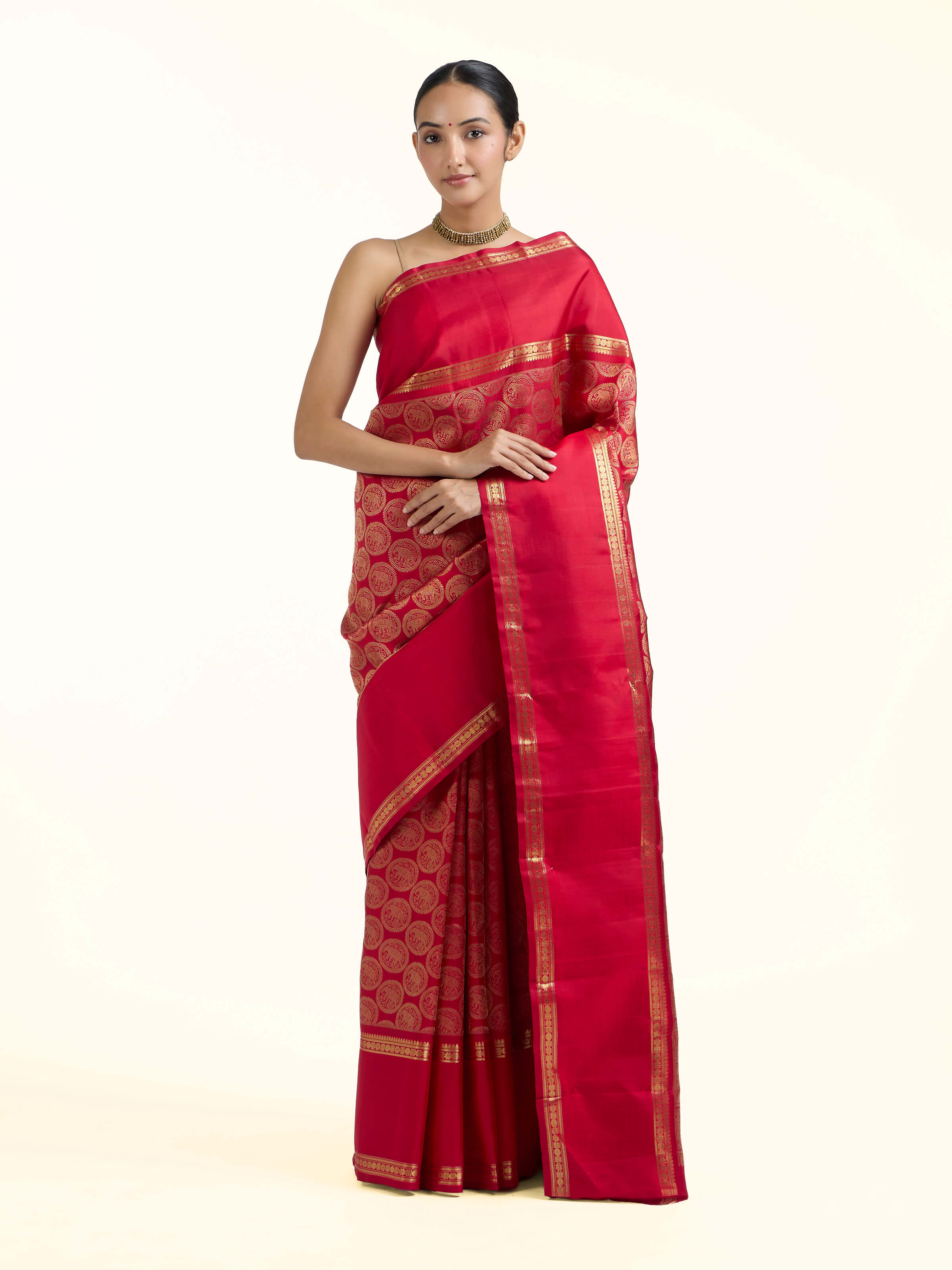 Front view of red silk Kancheepuram saree with rich zari woven motifs