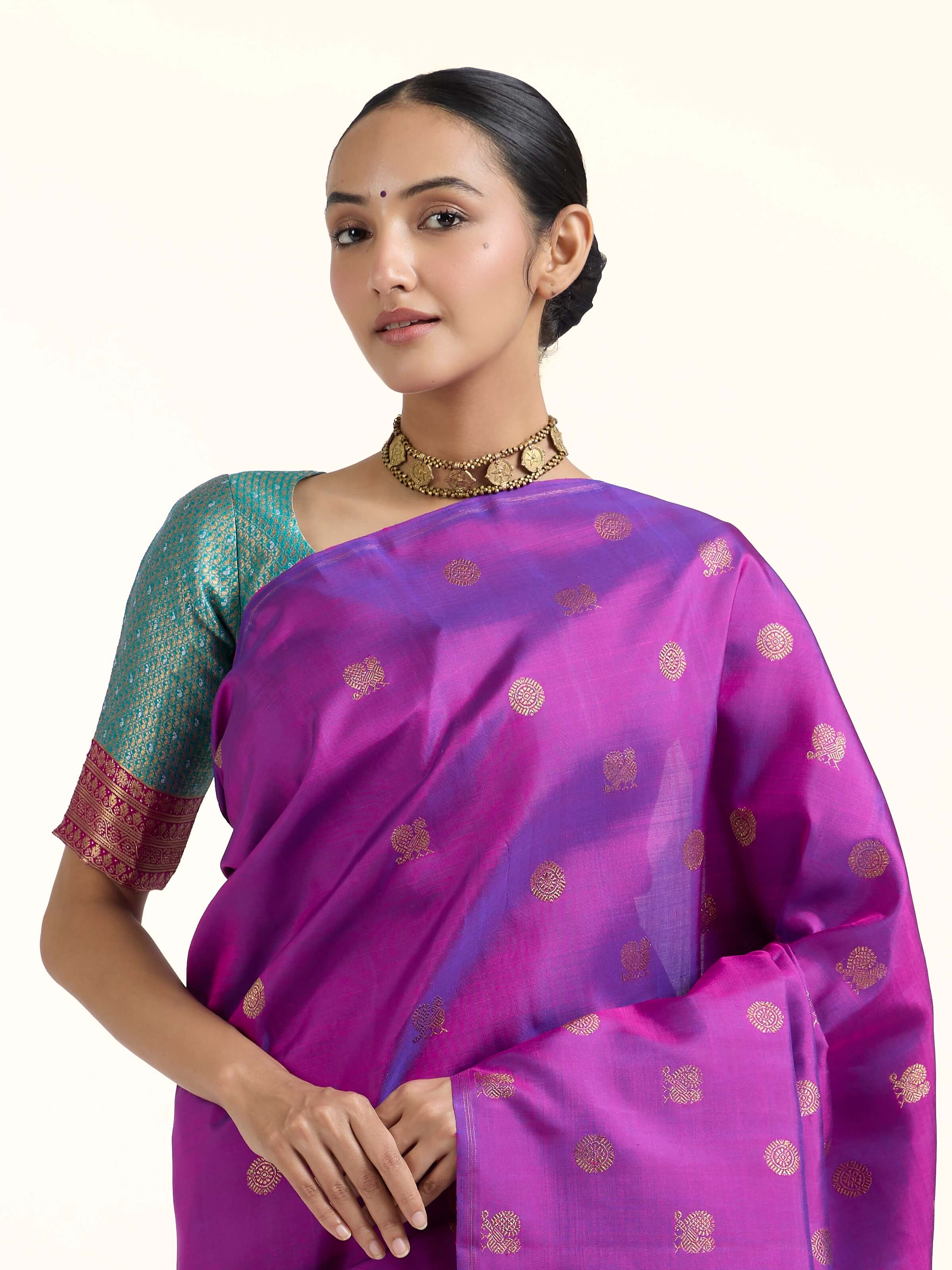Angled view of purple silk Kancheepuram saree highlighting lustrous weave