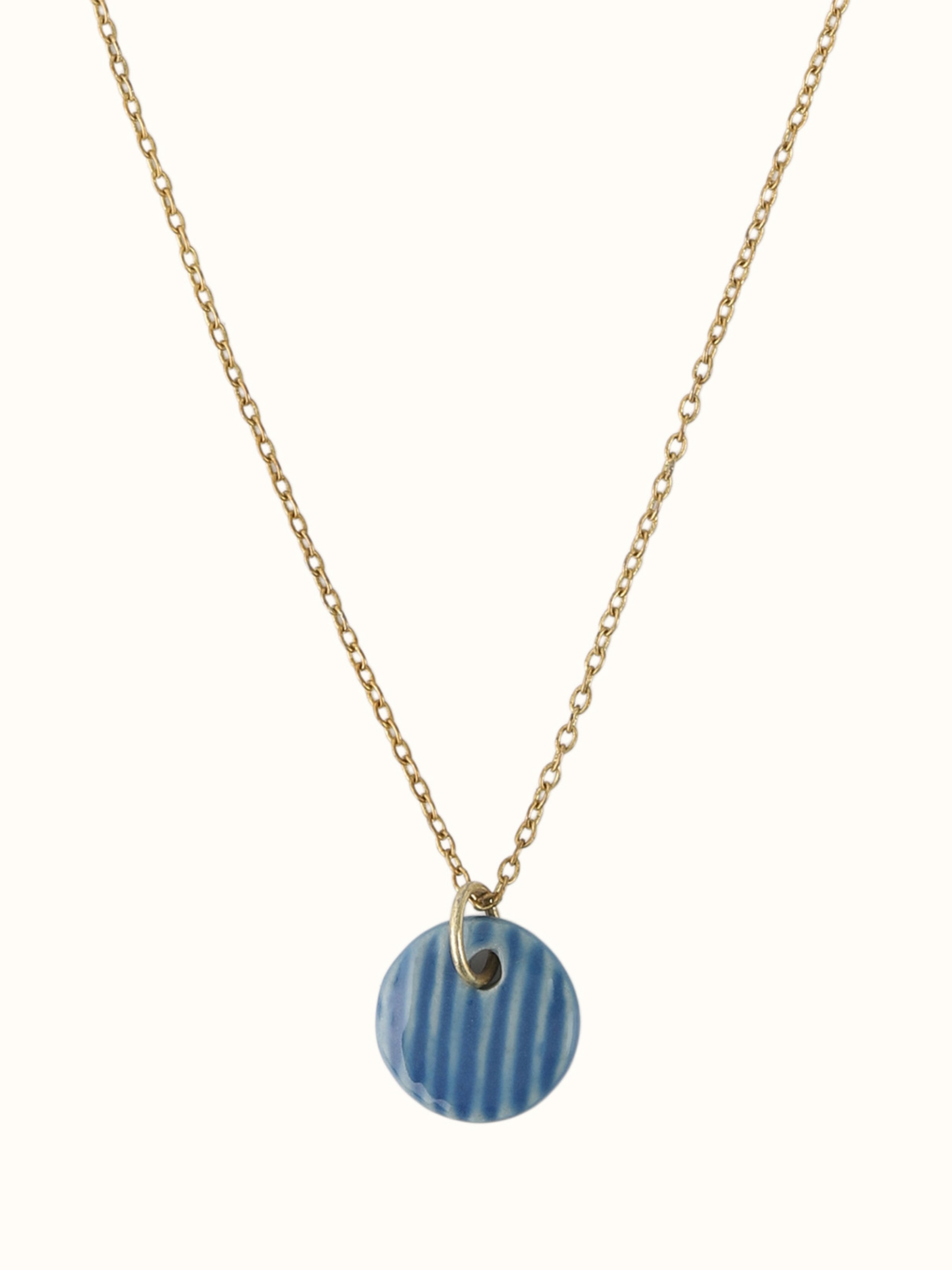 Close-up view of Ceramic Pendant & Chain showcasing the ceramic pendant’s smooth texture and color.