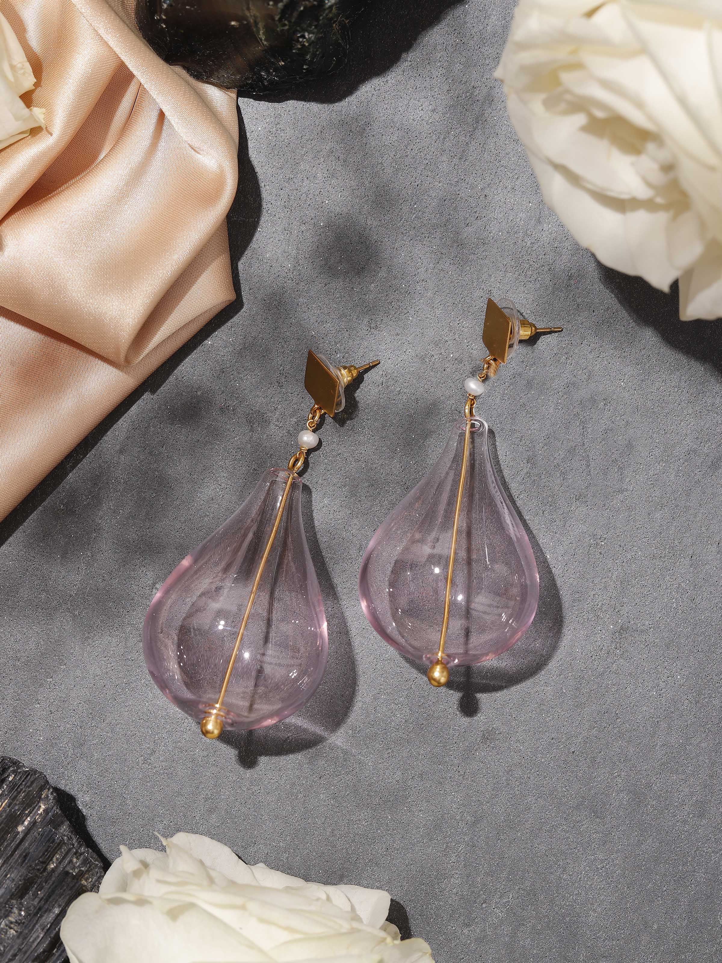 Lifestyle view of silver flame glass drop earrings