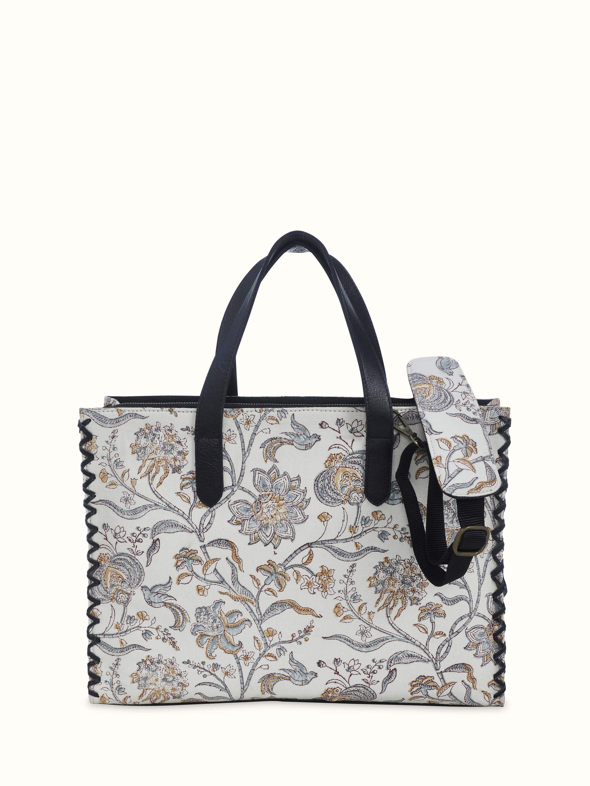 Black leather and textile hand block printed tote bag front view showing sturdy handles and block print design