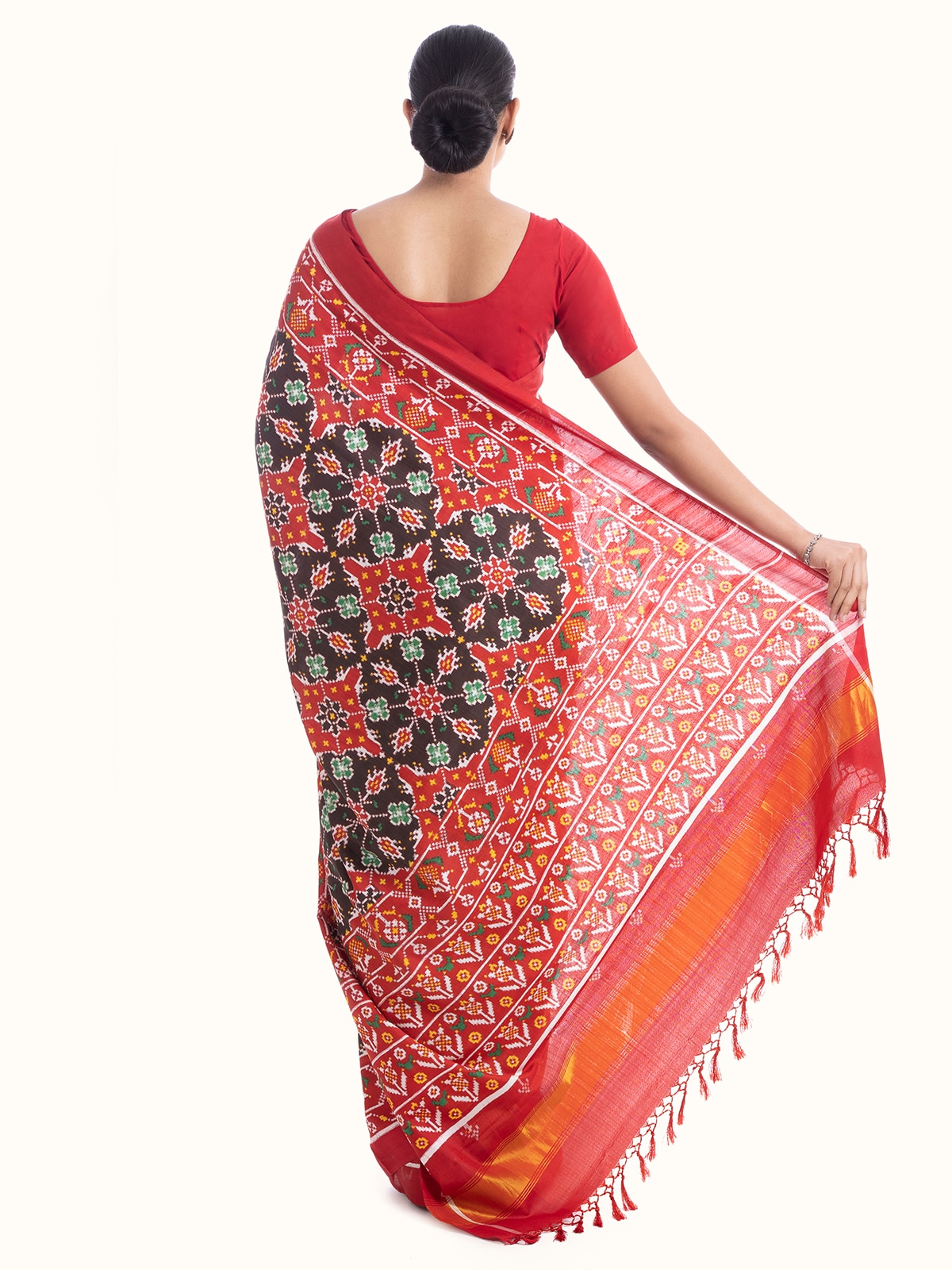 Back view of brown silk patola saree with emphasis on design and fabric flow