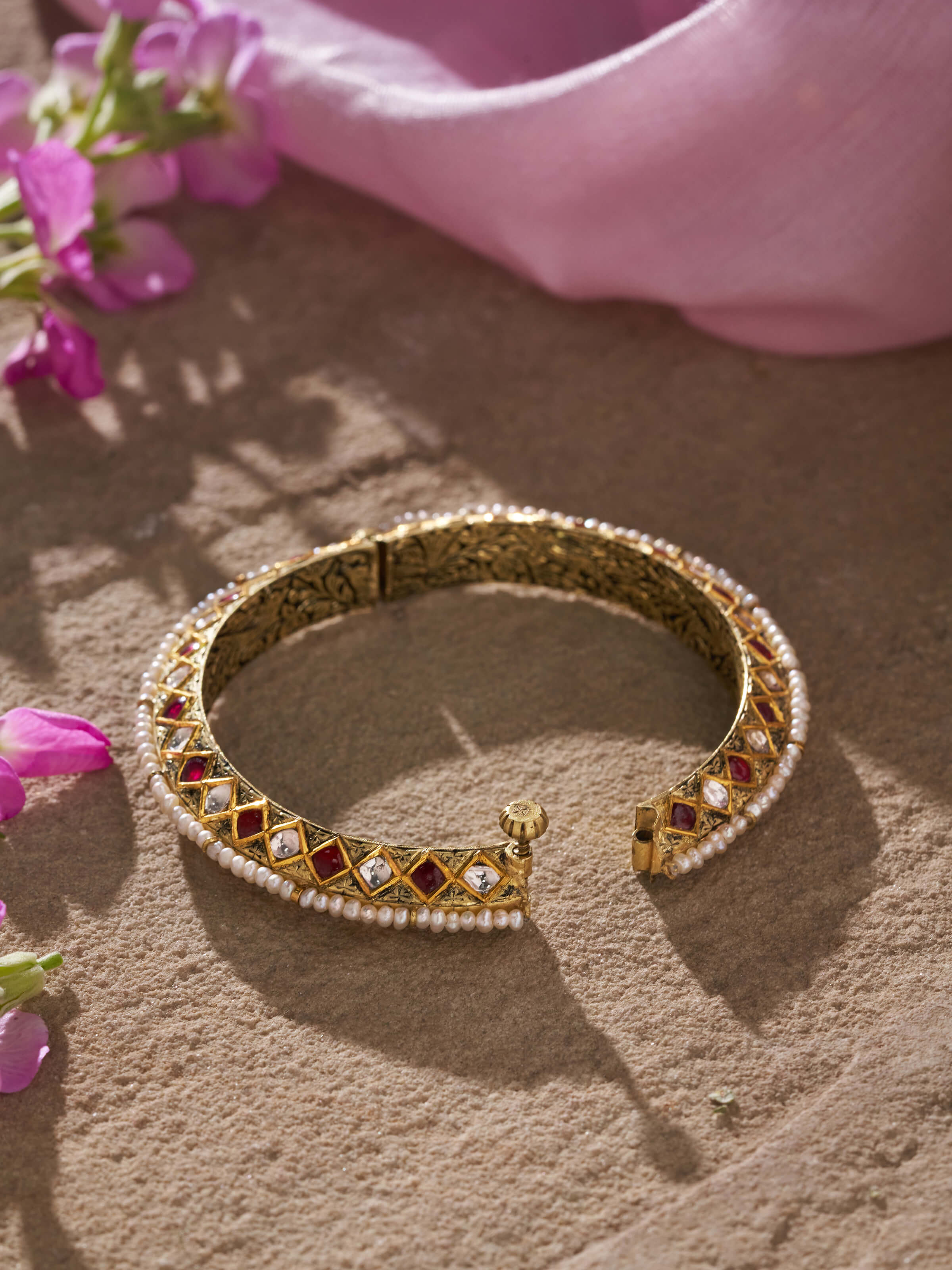 Detailed front view of 18 karat gold bangle with focus on craftsmanship