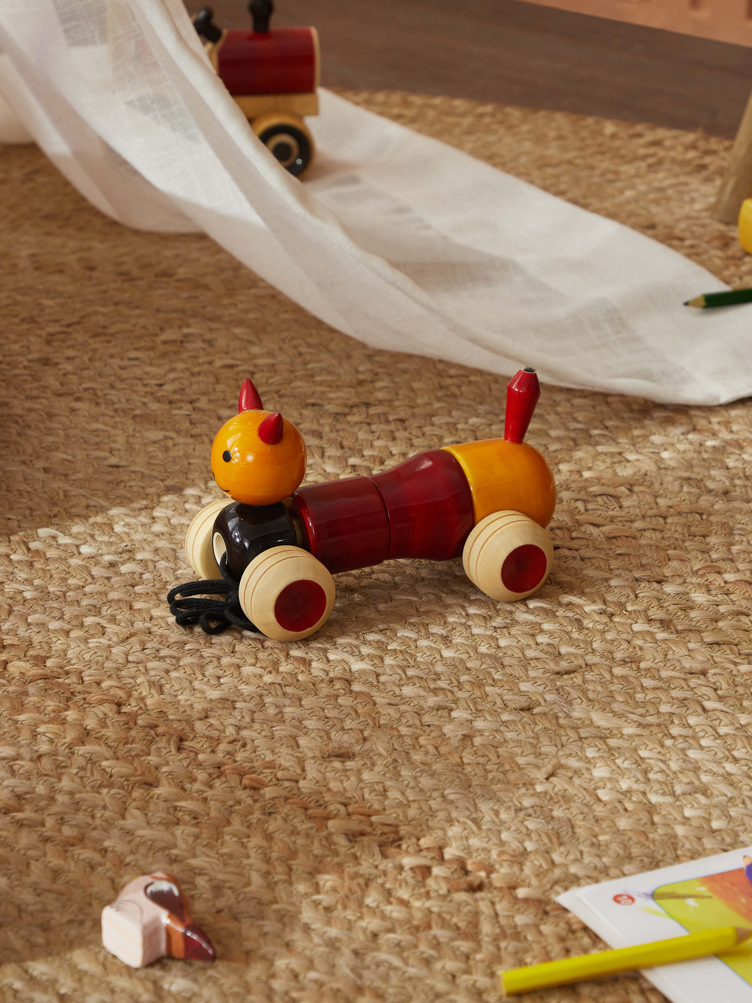 Close-up of Channapatna ivory wood bovow yellow toy, showing detailed craftsmanship and vibrant color.