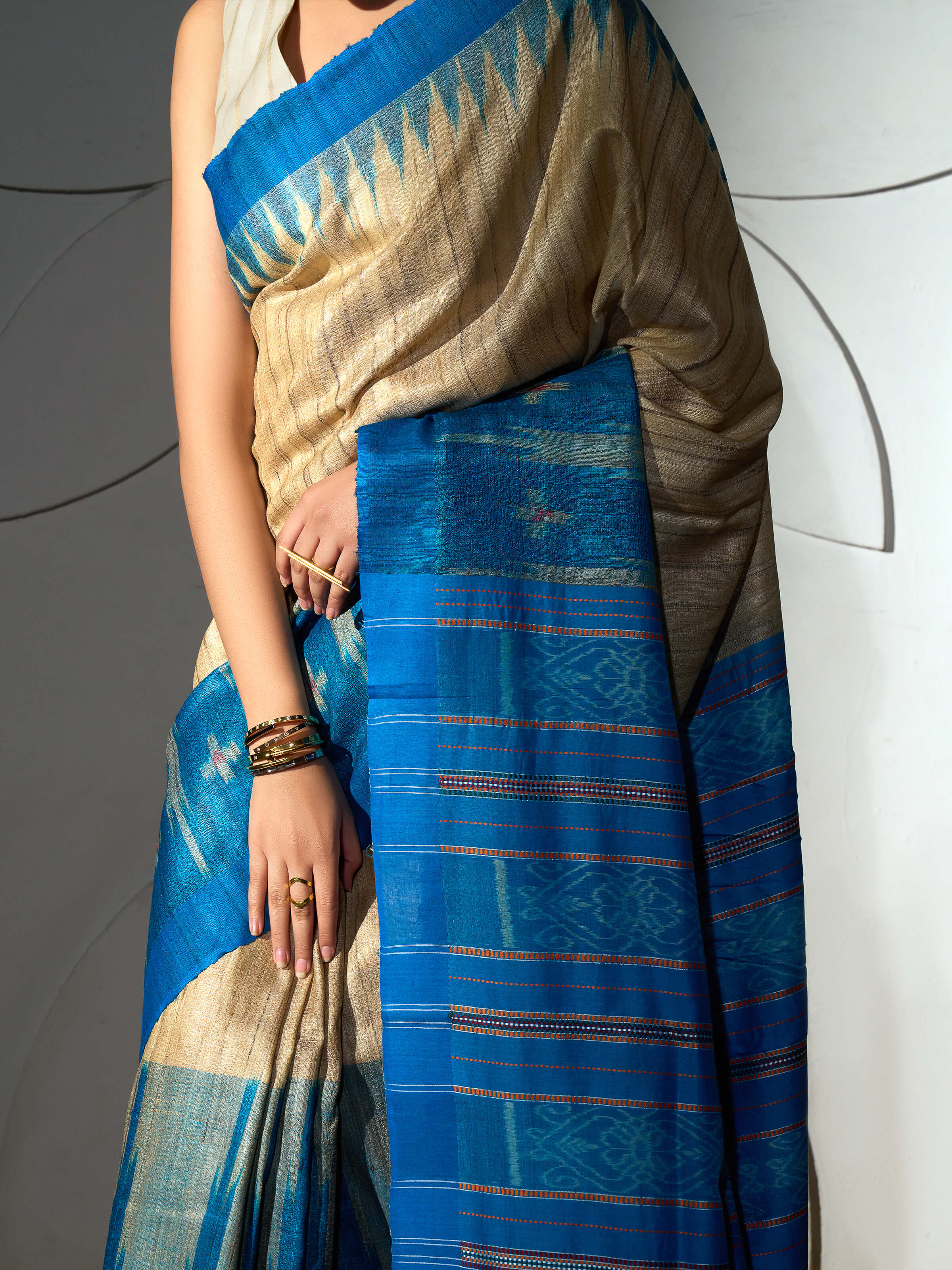 Detail view of turquoise tussar ghicha silk Bandha ikat saree showing fabric texture and ikat weave