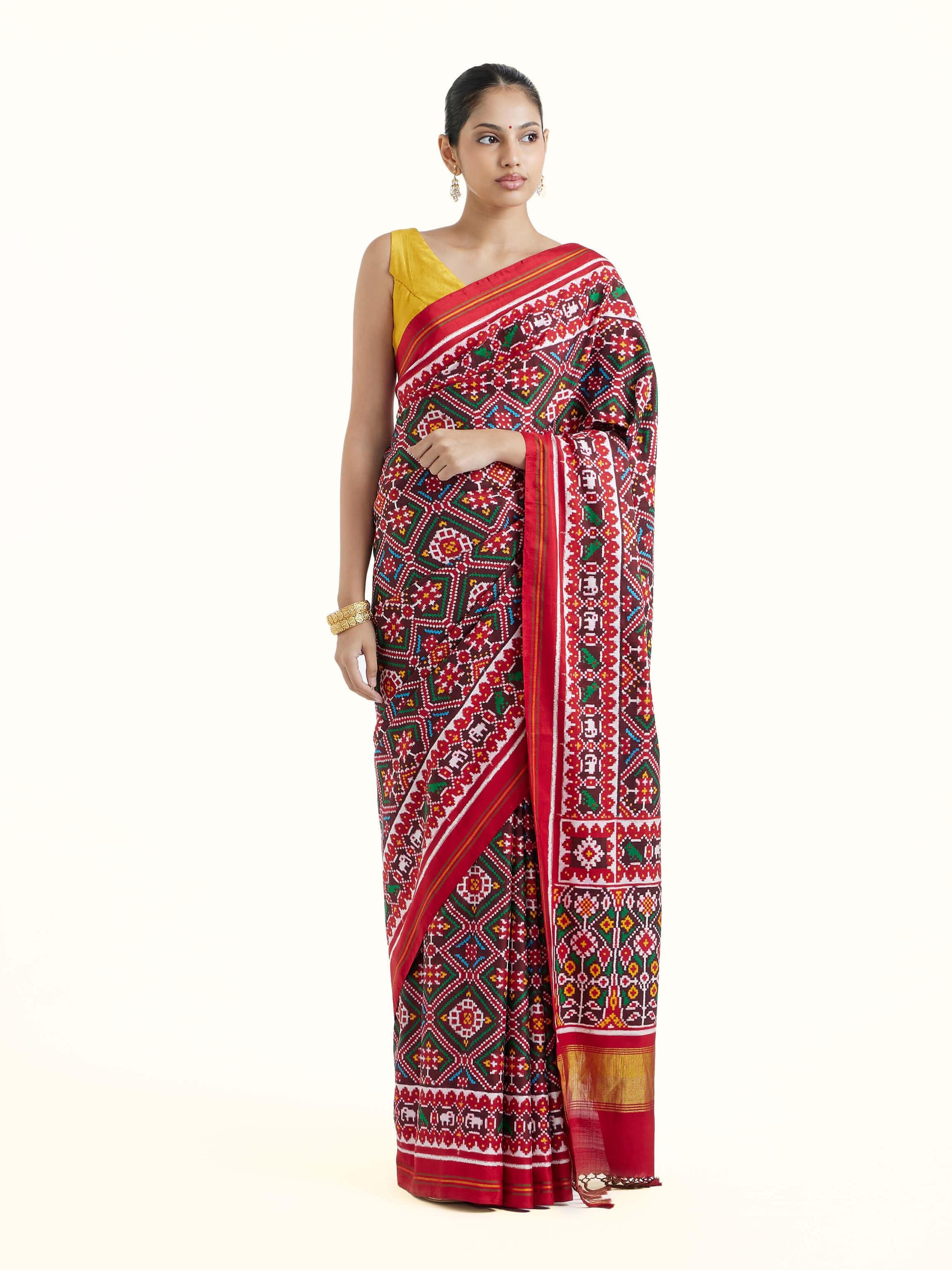 Front view of brown silk Patola saree showcasing traditional double ikat patterns