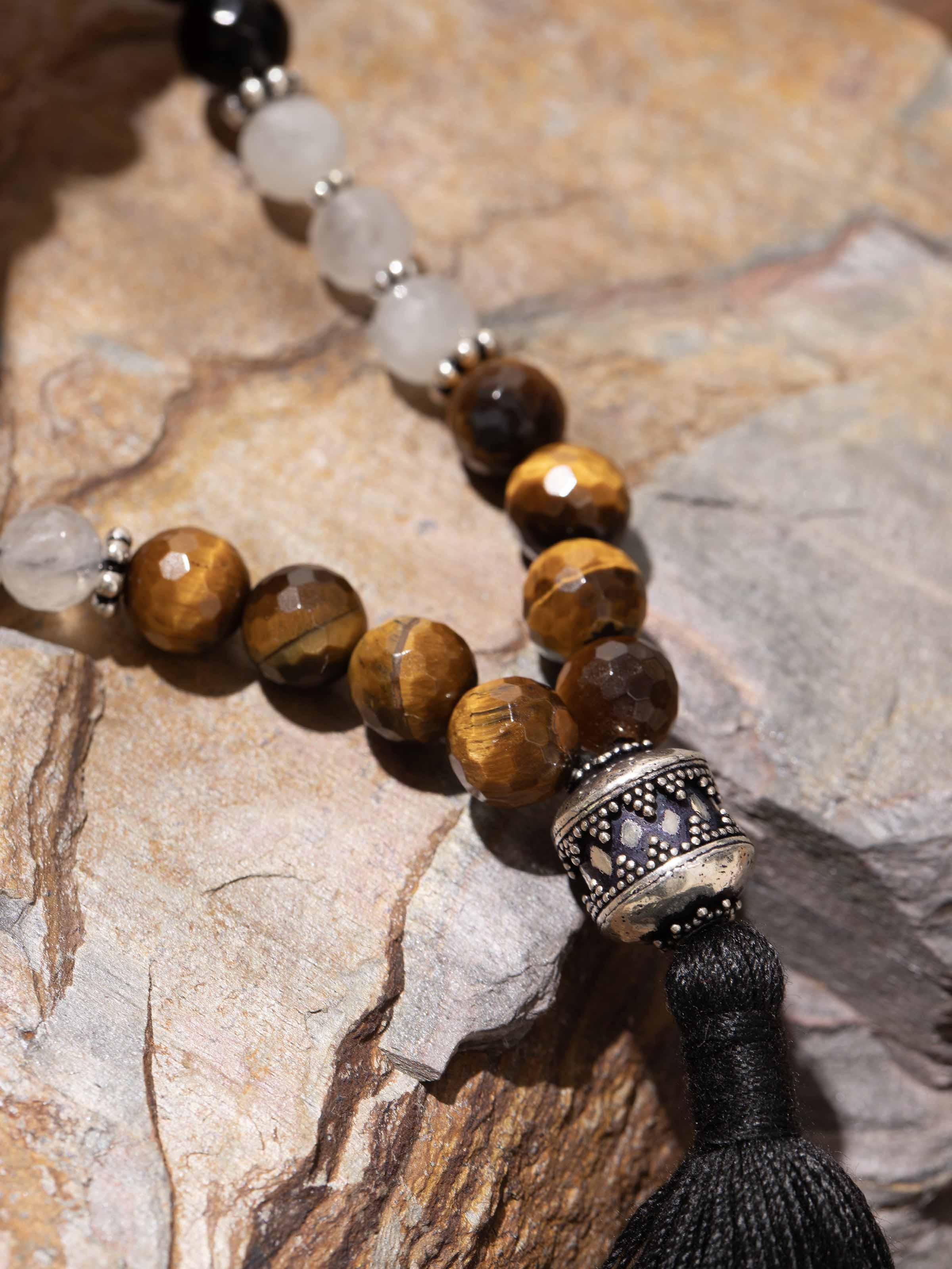 Close-up of mala beads with earthy tones and detailed craftsmanship in spiritual accessory