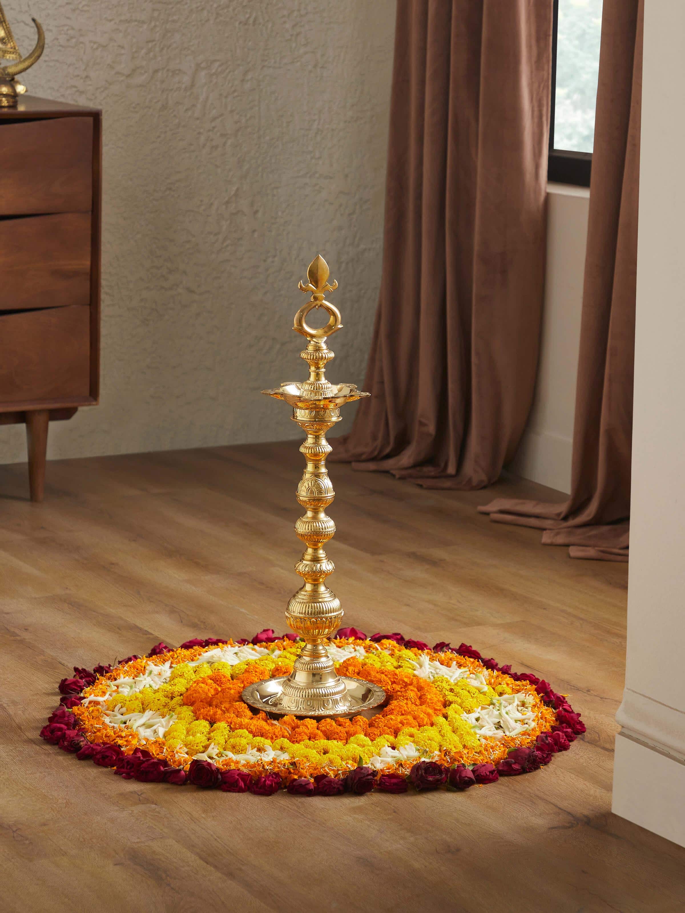 Side view of Vilakku Carved Brass Stand Diya emphasizing its detailed carving and elegant stand.