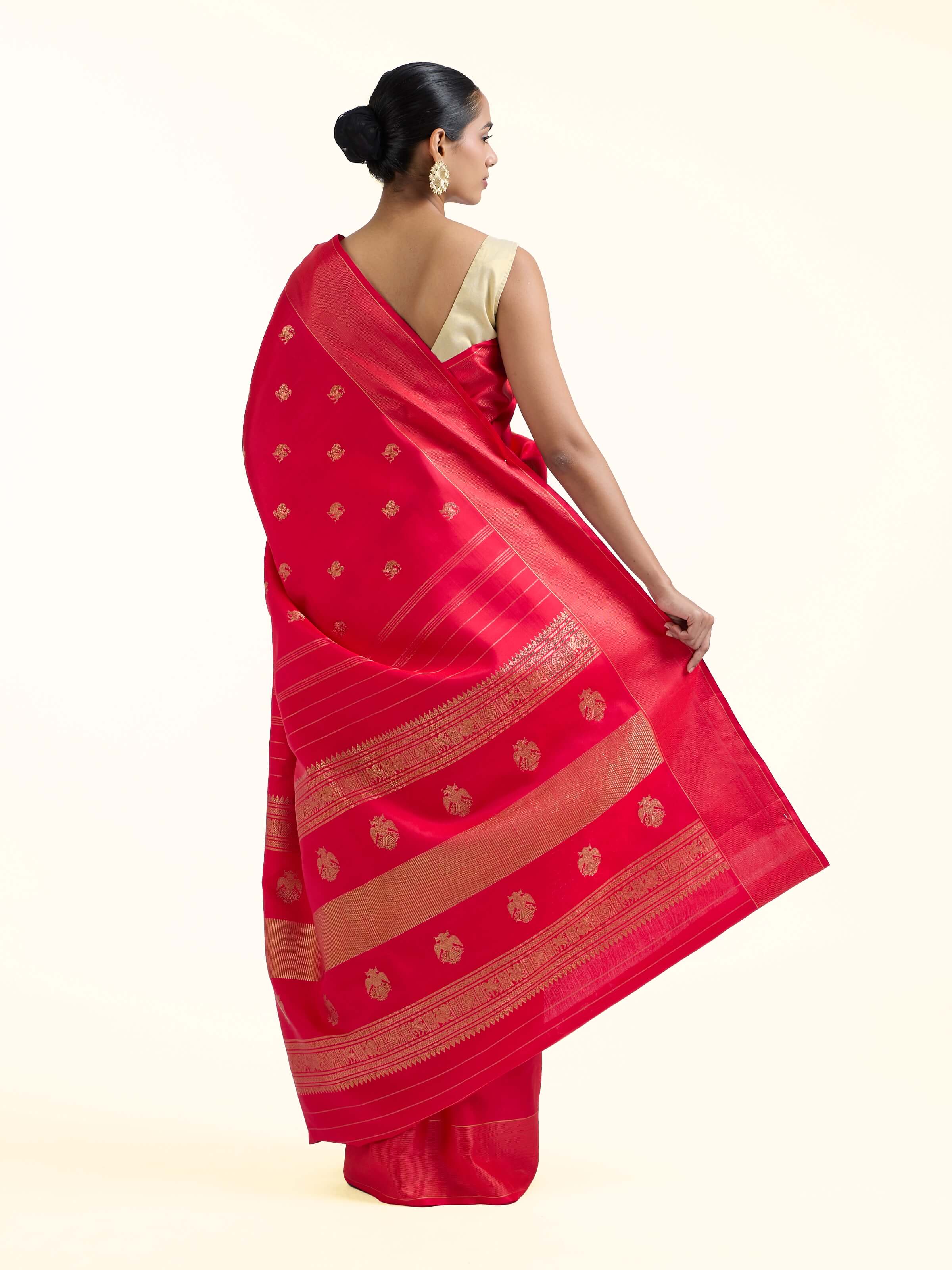 Back view of red silk Kancheepuram saree displaying ornate pallu design