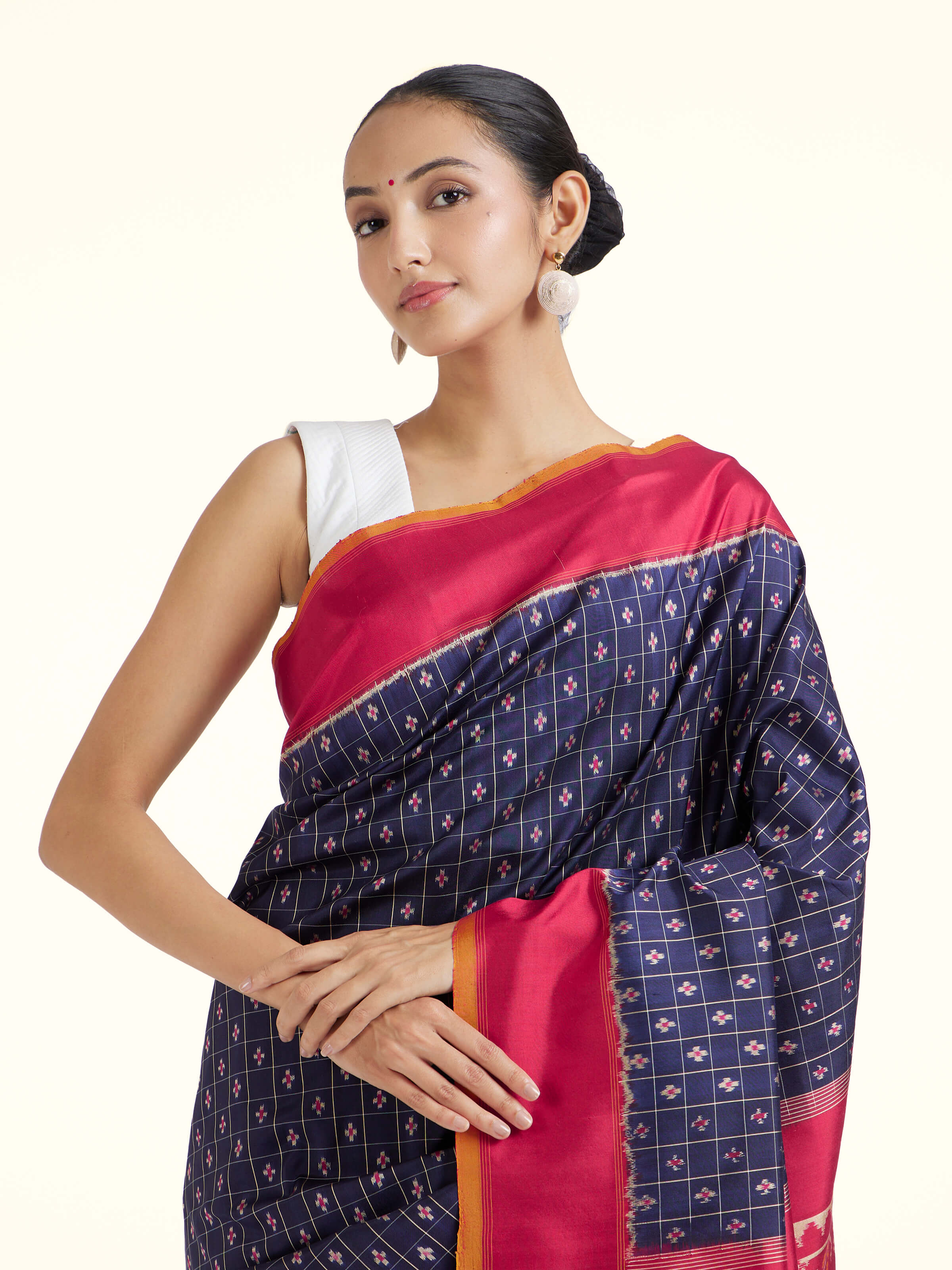 Angled view of navy mulberry silk Ikat saree emphasizing handcrafted Ikat weave