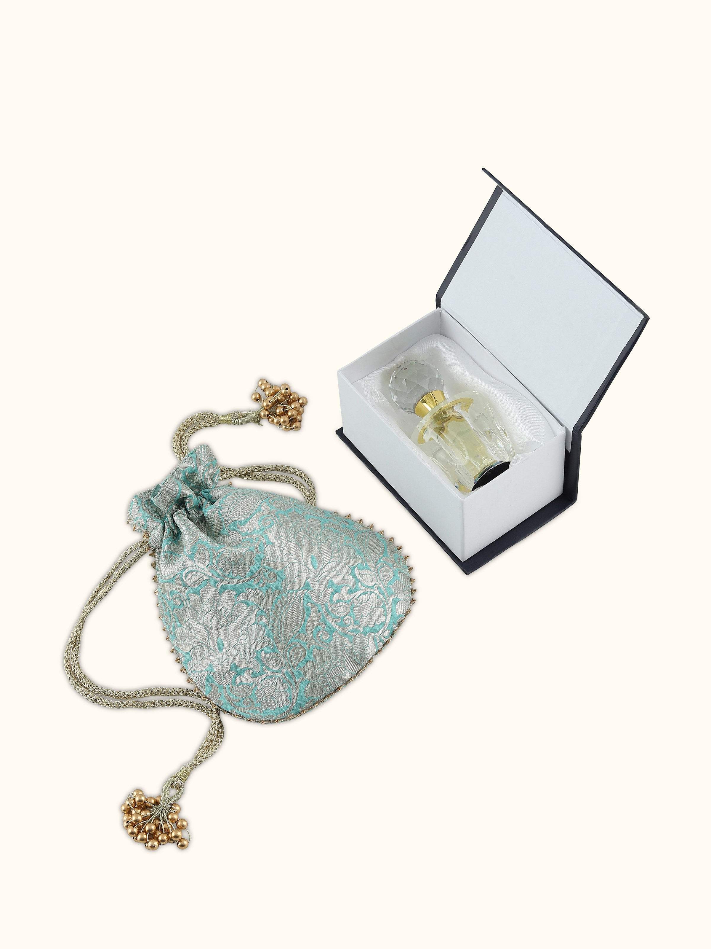 Angled view of Attar Aab (Aqua) perfume showing the transparency and shimmer of the liquid