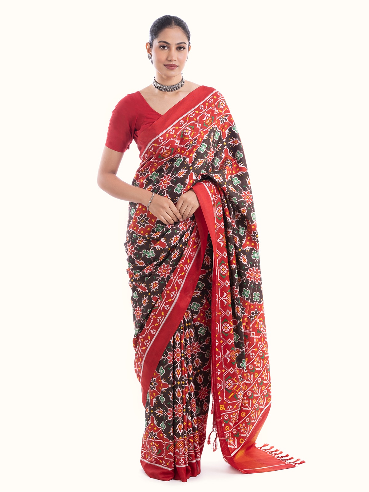 Front view of brown silk patola saree featuring elegant traditional patola patterns